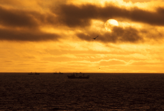 A sunset over Bering Sea crab fishing vessels