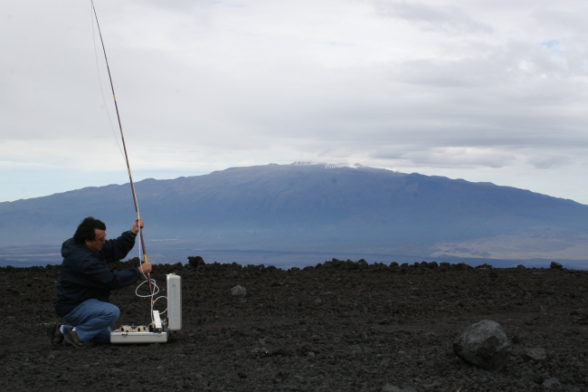 NOAA engineer Paul Fukumura-Sawada captures air near NOAA's Mauna LoaObservatory in Hawaii, using one of many methods to measure carbondioxide and other greenhouse gases in Earth's atmosphere