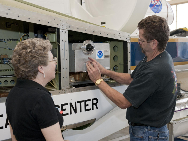 NOAA's laurel Watts and NASA Dryden's Dennis Pitts install NOAA's Ozoneinstrument on NASA's Global Hawk