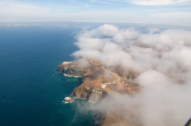 Aerial view of Santa Cruz Island seen through puffy cumulus