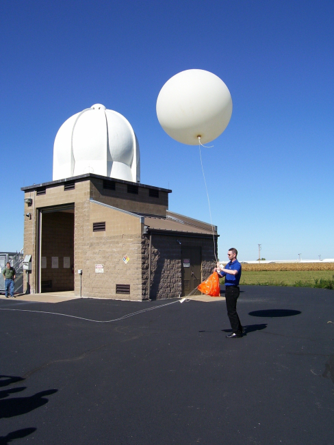 Tom (last name ?) launches a weather balloon during an open house