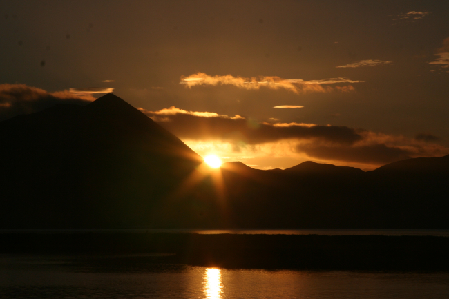 A bronze and gold sunset over Kodiak Island