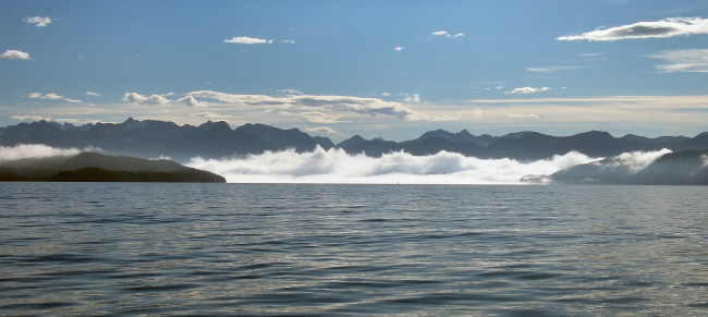 Clear offshore, fog nearshore in Prince William sound as the sun climbs higherin the sky