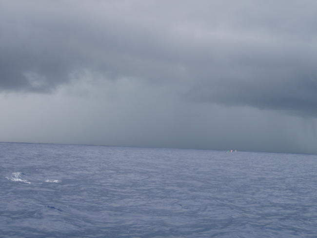 Small boat fishing operations on a squally day off the NOAA Ship OSCARELTON SETTE
