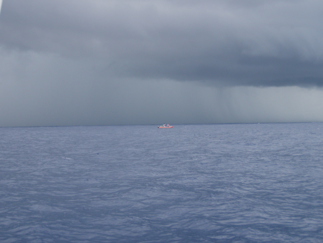 Small boat fishing operations on a squally day off the NOAA Ship OSCARELTON SETTE