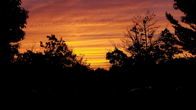 Sunset at fall equinox over the Germantown Marc train parking lot
