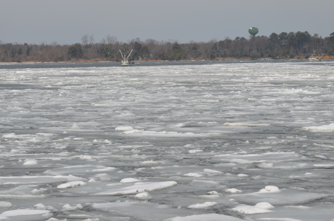 An oyster boat working the icy Patuxent River on a cold winter day