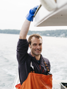 Photo of Chef Barton Seaver on a lobster boat.