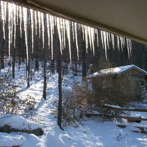 Icicles on the south side of a home illuminated on a bright winter morning