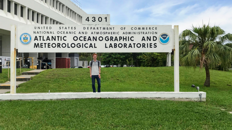 Nicholas Johnson, a 2018 NOAA Hollings scholar, stands in front of the Atlantic Oceanographic and Meteorological Laboratories sign in Miami, Florida.