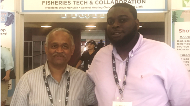 Nigel Lascelles (right) stands side by side with mentor Dr. Ashok Deshpande at the American Fisheries Society Center for Fisheries Tech and Collaboration.