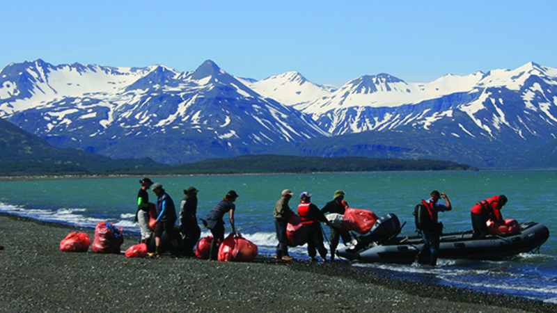 A NOAA-funded team removes marine debris from a remote beach in Alaska. 